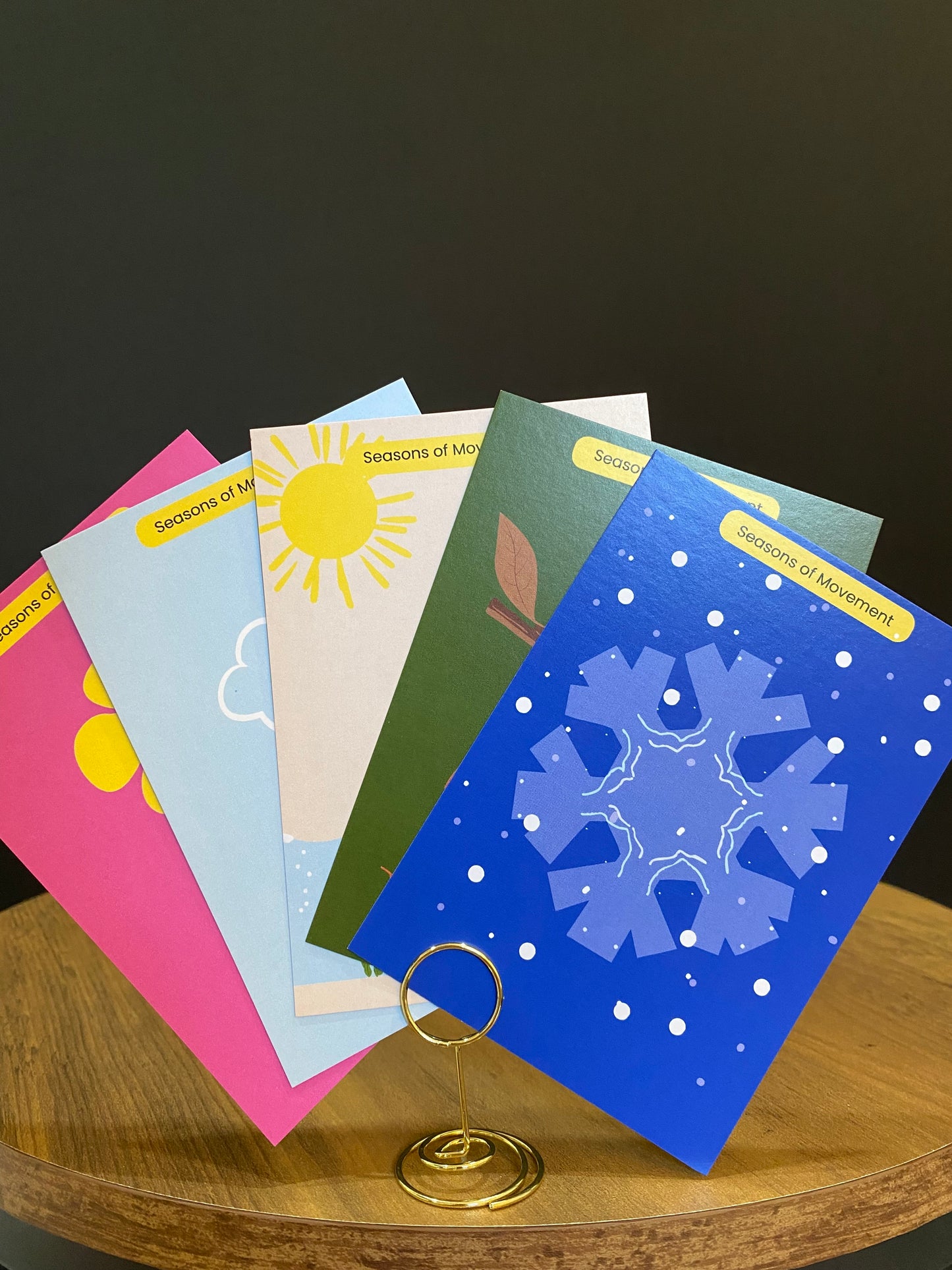 Set of colorful books with various designs on a wooden surface